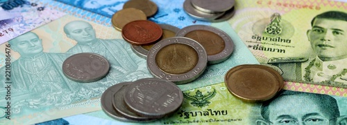 Obraz na plátně Thai baht money banknotes and coins on table