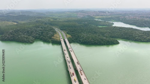 Aerial Reveal of Highway Bridge and Reservoir surrounded by Dense Forest