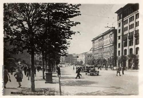 Moscow, USSR — circa 1950s: Cars and pedestrians on Teatralny Proyezd on a Soviet postcard
