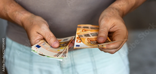 Hands counting fifty euro banknotes
