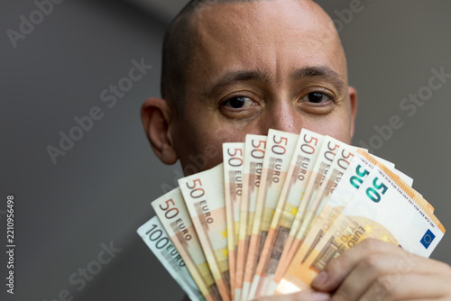 Man holding and counting euro banknotes