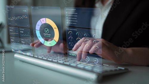 A person types on a keyboard. Portfolio monitoring compares investment performance and benchmark results, bringing volatility, drawdown and asset exposure into the assessment of risk.