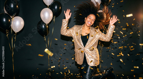Woman tossing her hair while dancing at a confetti party