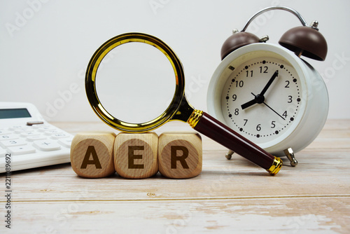 Obraz na plátně AER Annual Equivalent Rate alphabet letters with magnifying glass, calculator an