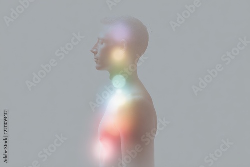 Side profile silhouette showing the chakra energy system with seven glowing colored centers for meditation and wellness background design