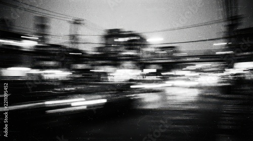 Motion blurred city street lights at night in black and white
