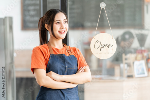 Asian Barista Smiling Arms Crossed Beside Hanging Open Sign