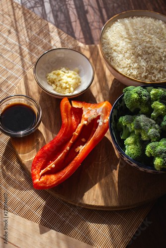 Raw rice, broccoli, red bell pepper, garlic and soy sauce