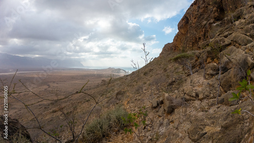 Fotografie Rocky mountainside above a dry valley. Socotra, Yemen.