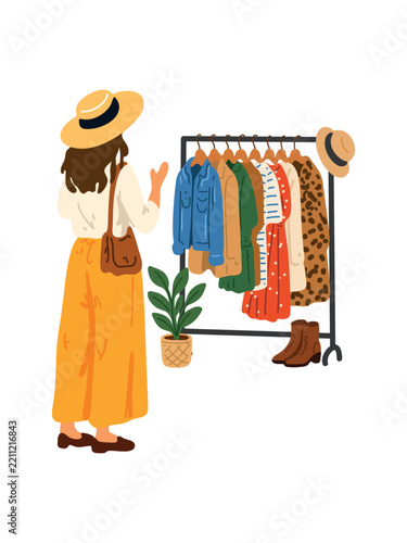 woman browsing clothing rack in fashionable boutique store