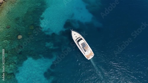 Luxury yacht sailing serene turquoise ocean waters aerial view during sunny day creating calm vacation mood