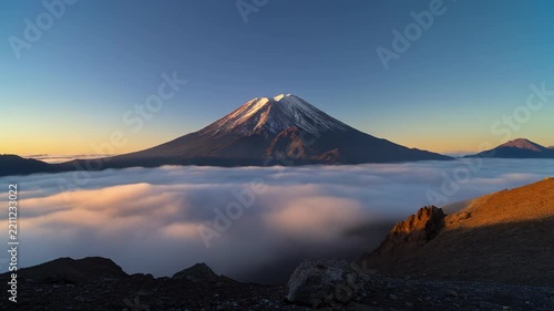 Majestic Mount Fuji veiled in morning mist during sunrise with cinematic motion and soft golden light
