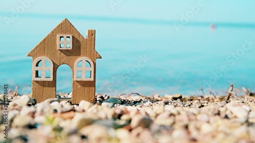 The symbol of the house standing on the seashore
