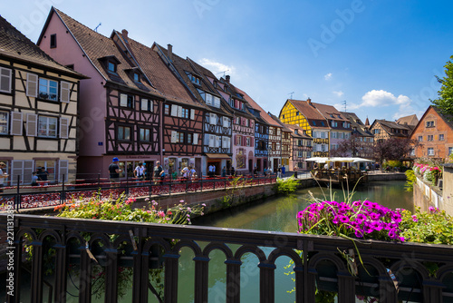 COLMAR, FRANCE, JULY 11, 2025 - The famous Petite Venise (Little Venice) in Colmar, Alsace, France, with its characteristic colorful half-timbered houses overlooking the canals of the Lauch River.