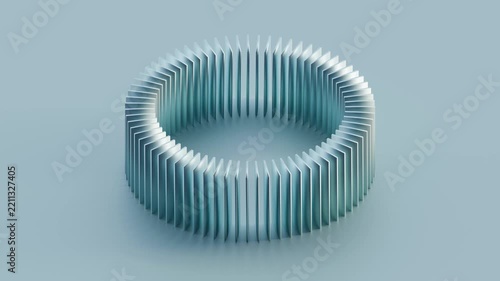 A circular formation of light blue metallic panels rotates in space