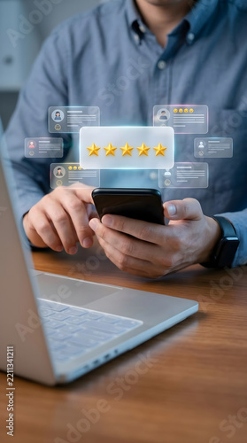 Man holding a smartphone and giving a five star customer rating with glowing feedback testimonial cards in an office environment