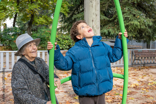 Grandma and grandson enjoying autumn playtime in park