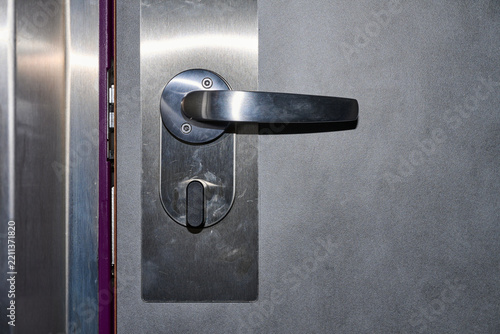 Close-up of the door handle of a room in a budget hotel.