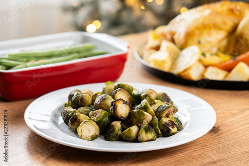Roasted Brussels sprouts on plate with festive background.