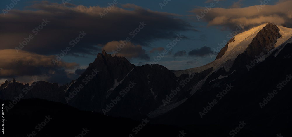 Obraz premium Summer view of the Mont Blanc massif above forested slopes 