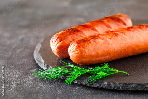 grilled sausages on slate stone, selective focus