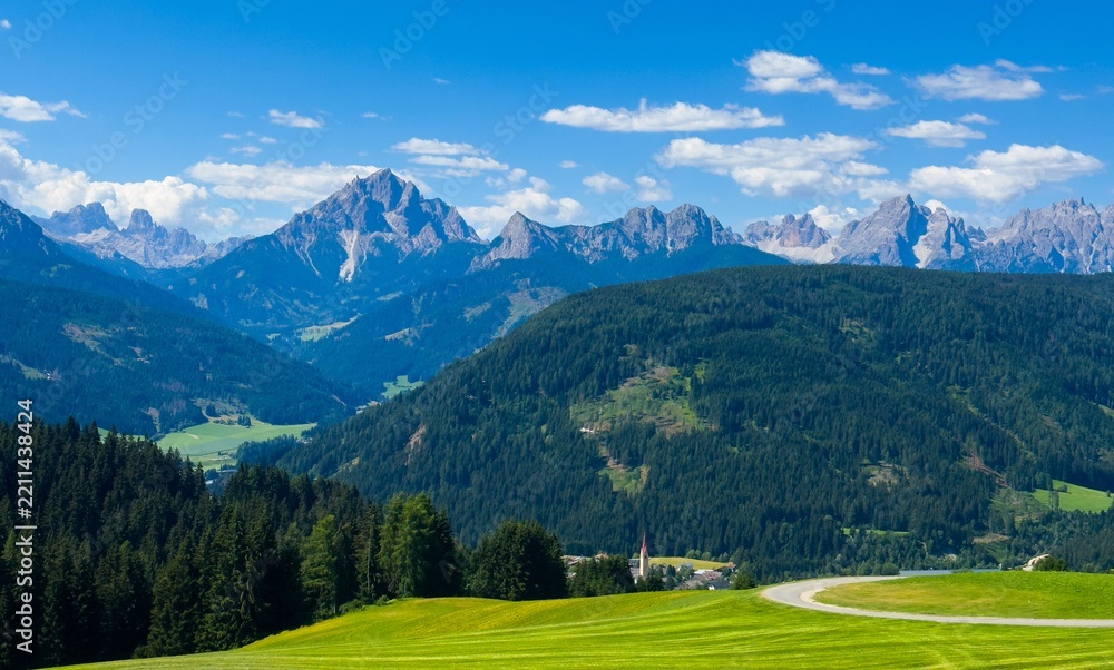 Obraz premium Majestic scenery of rough mountain ridge near grassy hills 