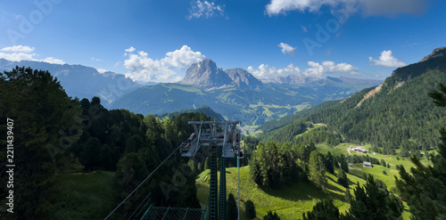 Aerial view from cable car gondola over Alpine valley and pine forest, Seceda, Val Gardena, Dolomites, Italy Stock Photo