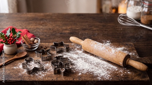 Christmas baking scene with rolling pin cookie cutters and flour