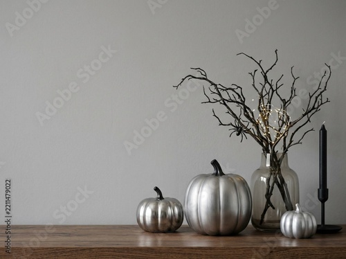 Modern Halloween decor with silver pumpkins and black branches