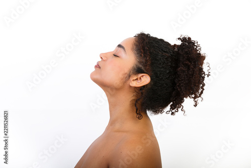 Woman with curly hair in profile showing skin care routine and self-care habits