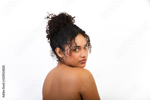 Skin care routine model with natural curls in minimalistic setting