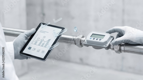 Industrial water meter audit supports sustainability with digital tablet monitoring and measured pipeline connection