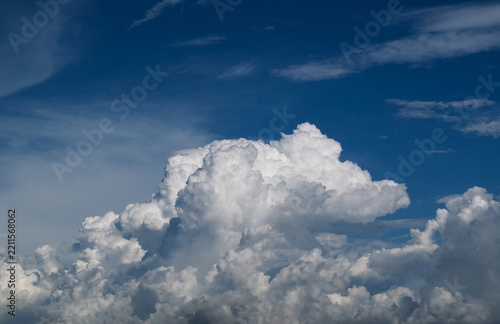 Large fluffy white cumulus clouds in blue sky