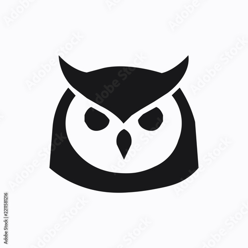 Black owl head silhouette icon with sharp eyes isolated on white background 