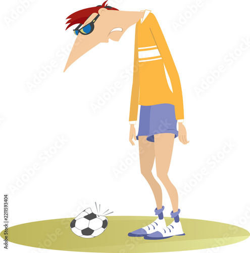 Puzzled football player stands near a broken ball