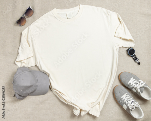 Blank ivory unisex t-shirt mockup, crewneck flat lay with denim jeans and mens accessories