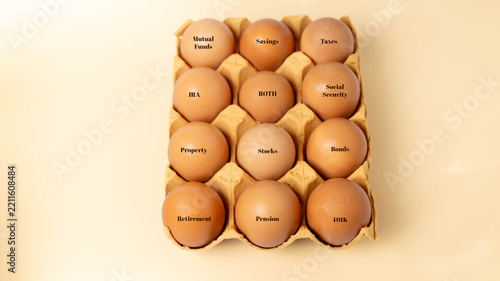 Fragile investment finance concept using a dozen of brown eggs in a paper carton depicting the fragility and risk of planning options for retirement.