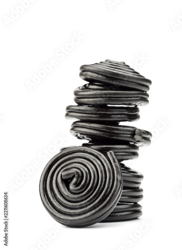 Liquorice candy wheels pile, isolated on white background.