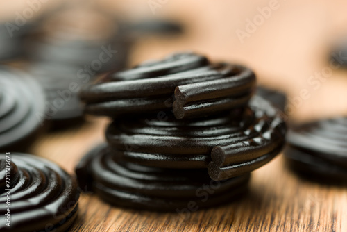 Liquorice candy wheels bunch on wooden table.