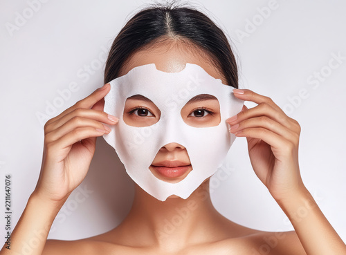 Woman applying a facial mask for skincare routine at home
