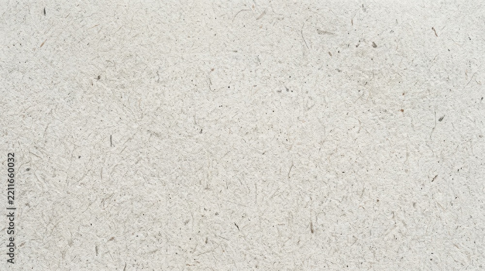 Fototapeta premium Close up of textured off white paper with subtle speckles.
