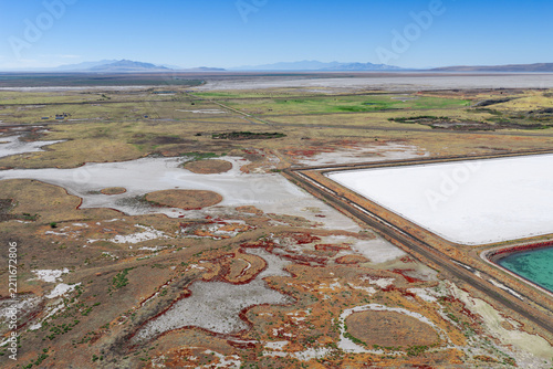 Aerial view of wastewater evaporation ponds by the Great Salt Lake with crystalized salt and crusted salty ground in Ogden, Utah, United States.