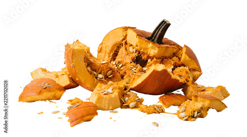 Smashed pumpkin with scattered seeds and pulp on a white background.