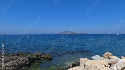 Rocky mediterranean coastline with clear water and scattered stones at Favignana island, Sicily, Italy