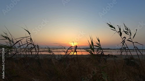 Golden sunset over tranquil salt pans near Trapani, Italy
