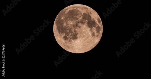 Beautiful detailed full moon rising in a black night sky time lapse video footage