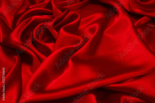Rich and luxury red silk fabric texture background.