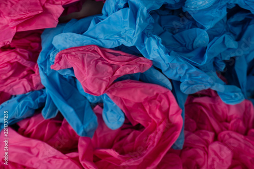 Pink and blue latex sterile medical gloves as a background.