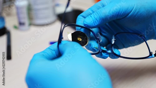 Medical optician technician processing custom vision correction lenses