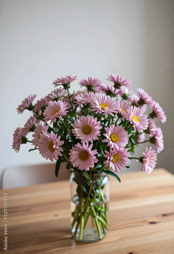 Fototapeta premium Wellness and home decor, bouquet of pink daisy flowers in a glass vase on a wooden table for interior design and spring seasonal lifestyle